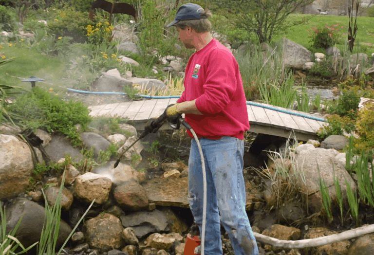 Doug pressure washing a pond